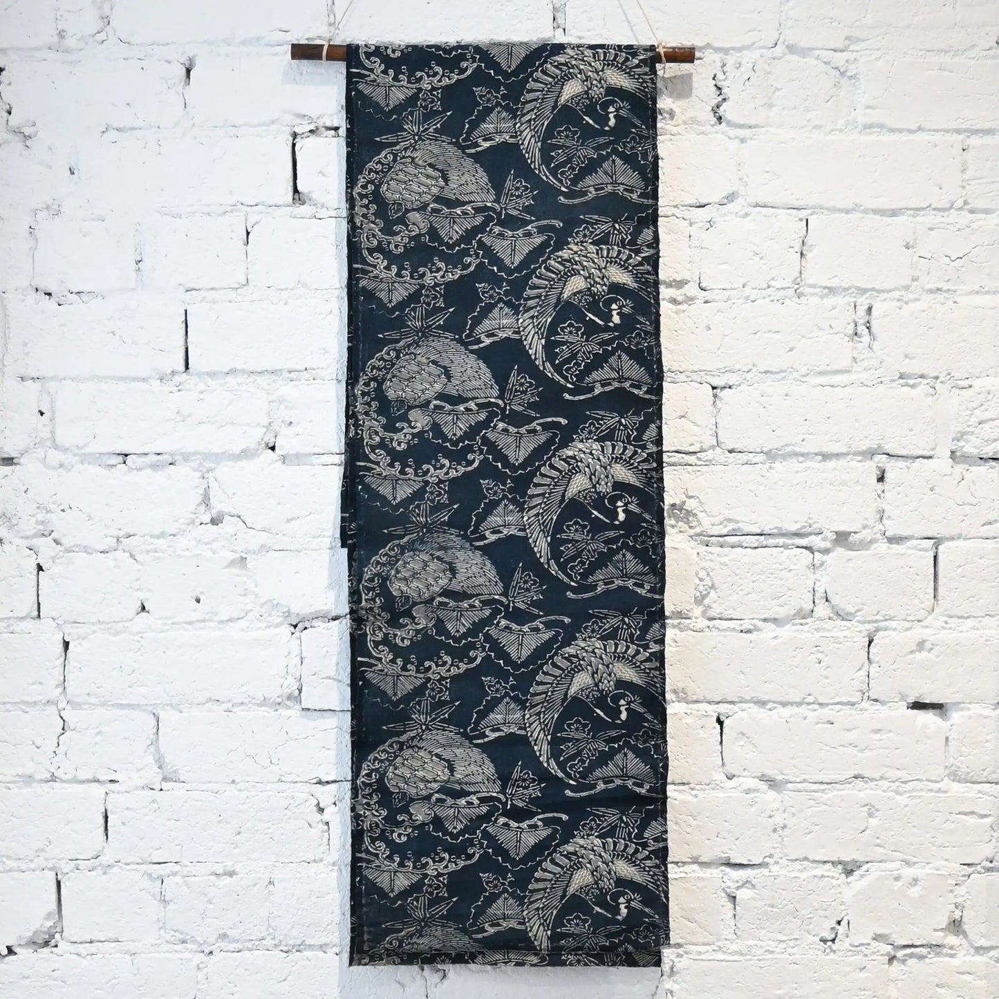 Hanging view of antique indigo Katazome dyed cotton with crane and tortoise form the early 20th century.