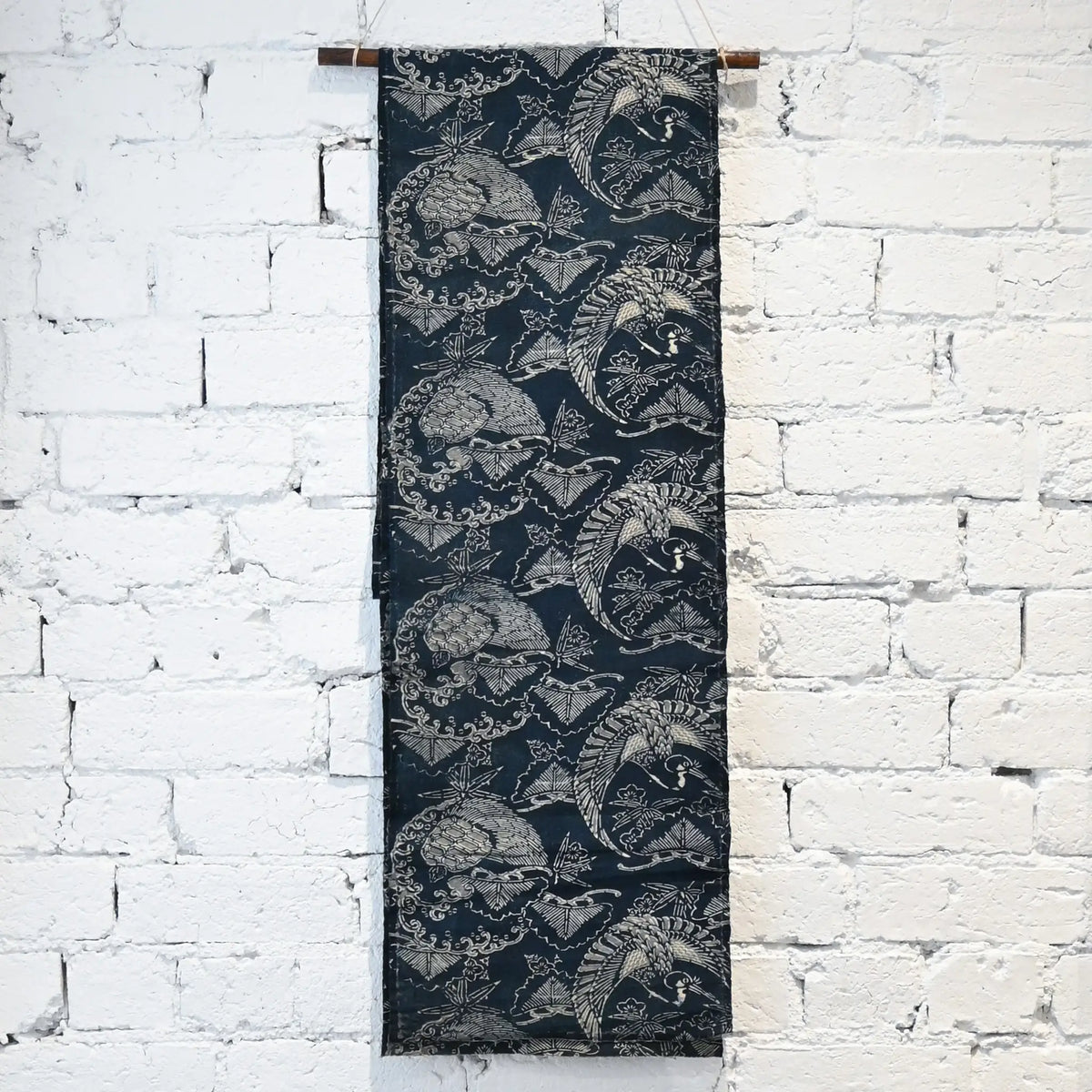 Hanging view of antique indigo Katazome dyed cotton with crane and tortoise form the early 20th century.