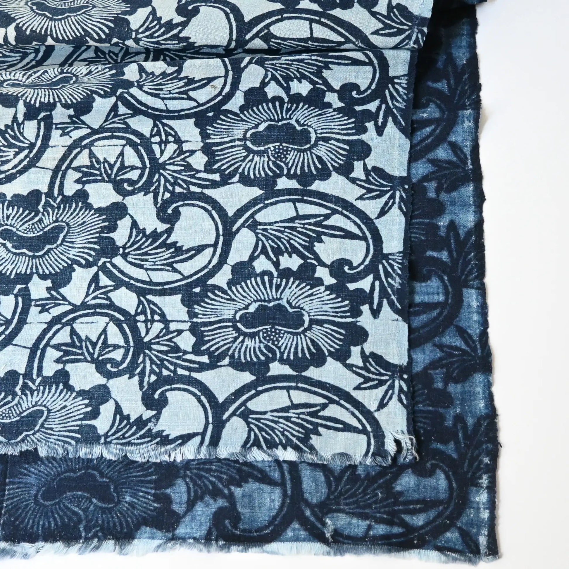 Antique indigo katazome cotton with peony arabesque motif in layered indigo tones.