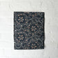 Antique indigo katazome dyed cotton piece with abstract floral motif, indigo with Bengala red and grey accents.