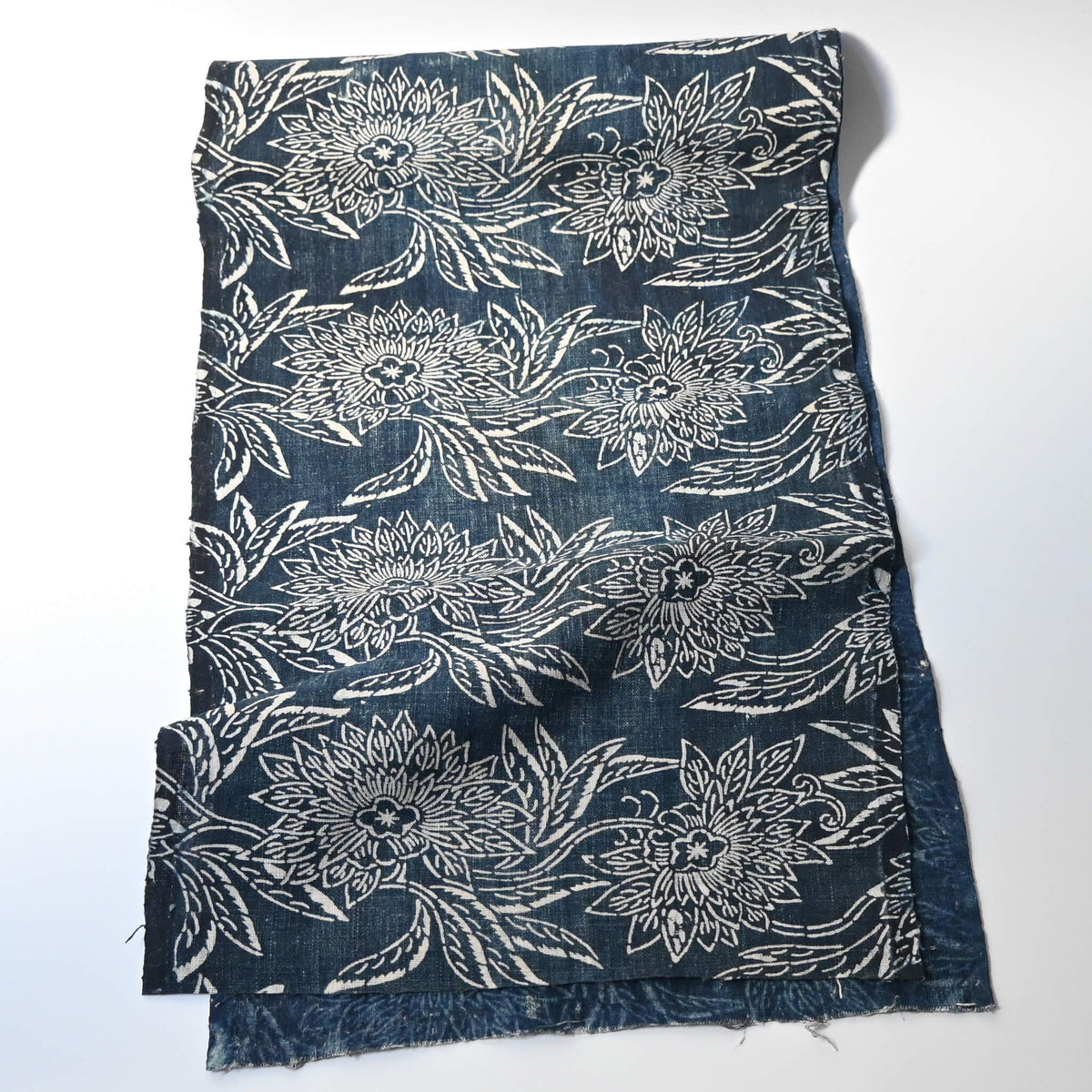 Full view of antique indigo katazome dyed cotton futon cover panel with chrysanthemum pattern.m