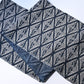 Antique Japanese indigo katazome dyed cotton with a repeating pattern of paired cranes within diamond-shaped motifs.