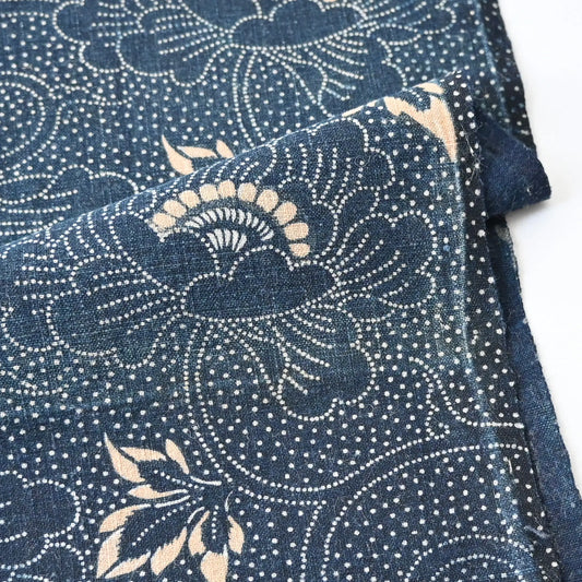 Close-up view of antique indigo katazome futon cover panel with peony arabesque from early 20th century.