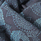 Close-up view of antique indigo katazome dyed cotton futon cover panel with chrysanthemum motif.