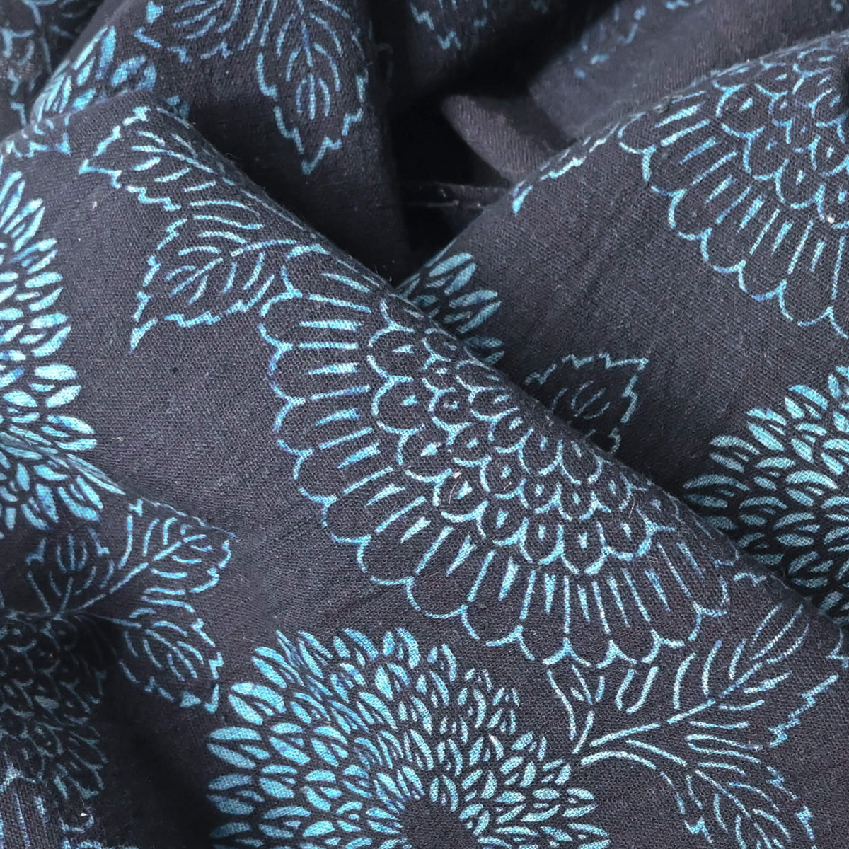 Close-up view of antique indigo katazome dyed cotton futon cover panel with chrysanthemum motif.
