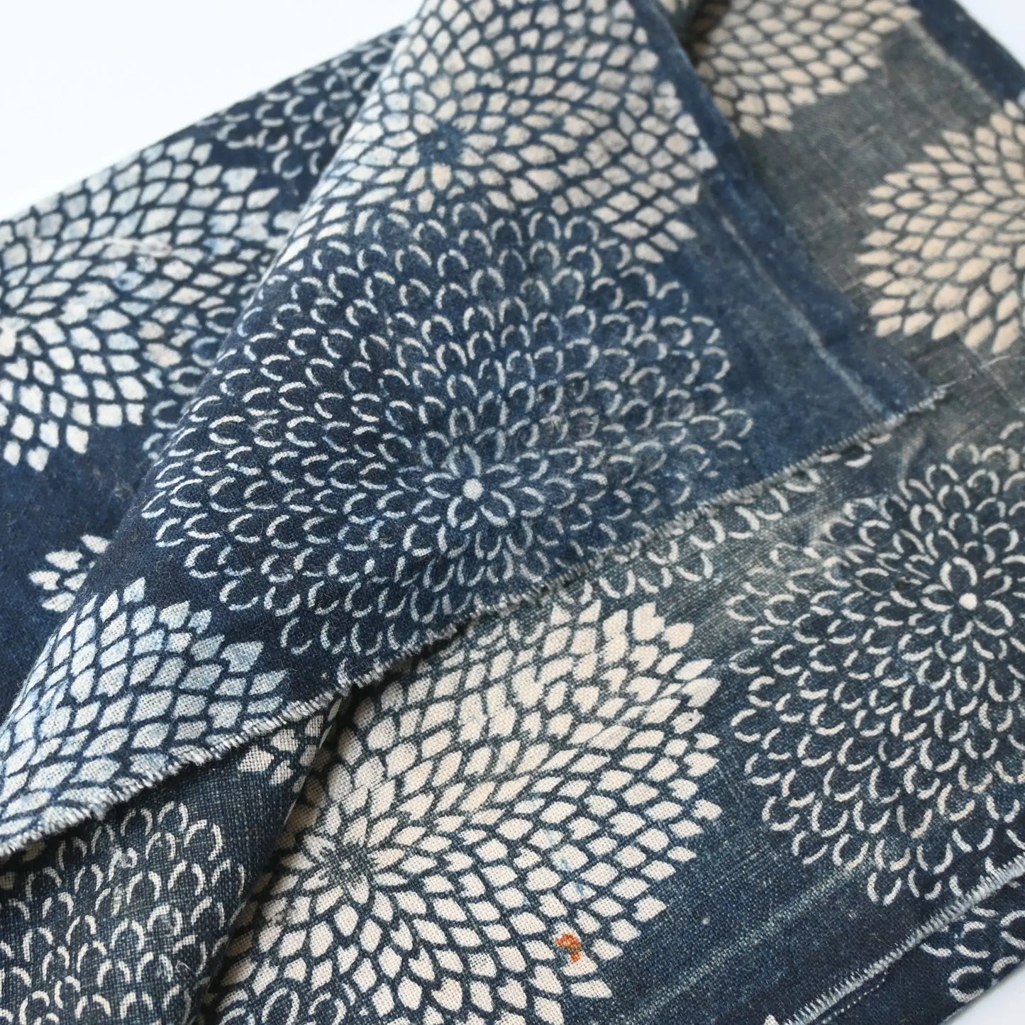 Detailed view of antique indigo Katazome dyed cotton with chrysanthemum pattern from the early 20th century.