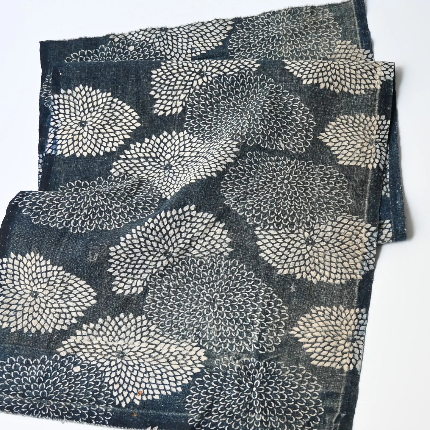 Detailed view of antique indigo Katazome dyed cotton with chrysanthemum pattern from the early 20th century.