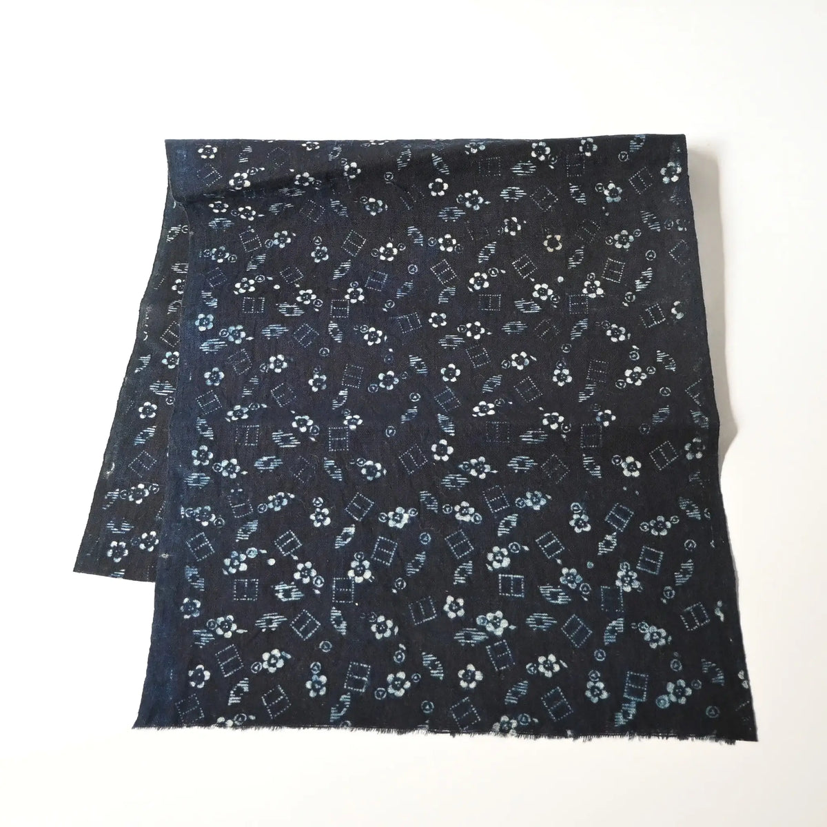 Full view of antique indigo katazome dyed cotton with fine dots and lines, and plum blossoms, early 20th century.