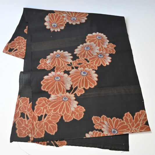 Full view of antique Japanese black lightweight fine silk kimono fabric with chrysanthemum motif.