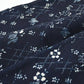 Detailed view of antique Japanese indigo Katazome cotton with intricate dots, lines and cherry blossoms from the early 20th century.
