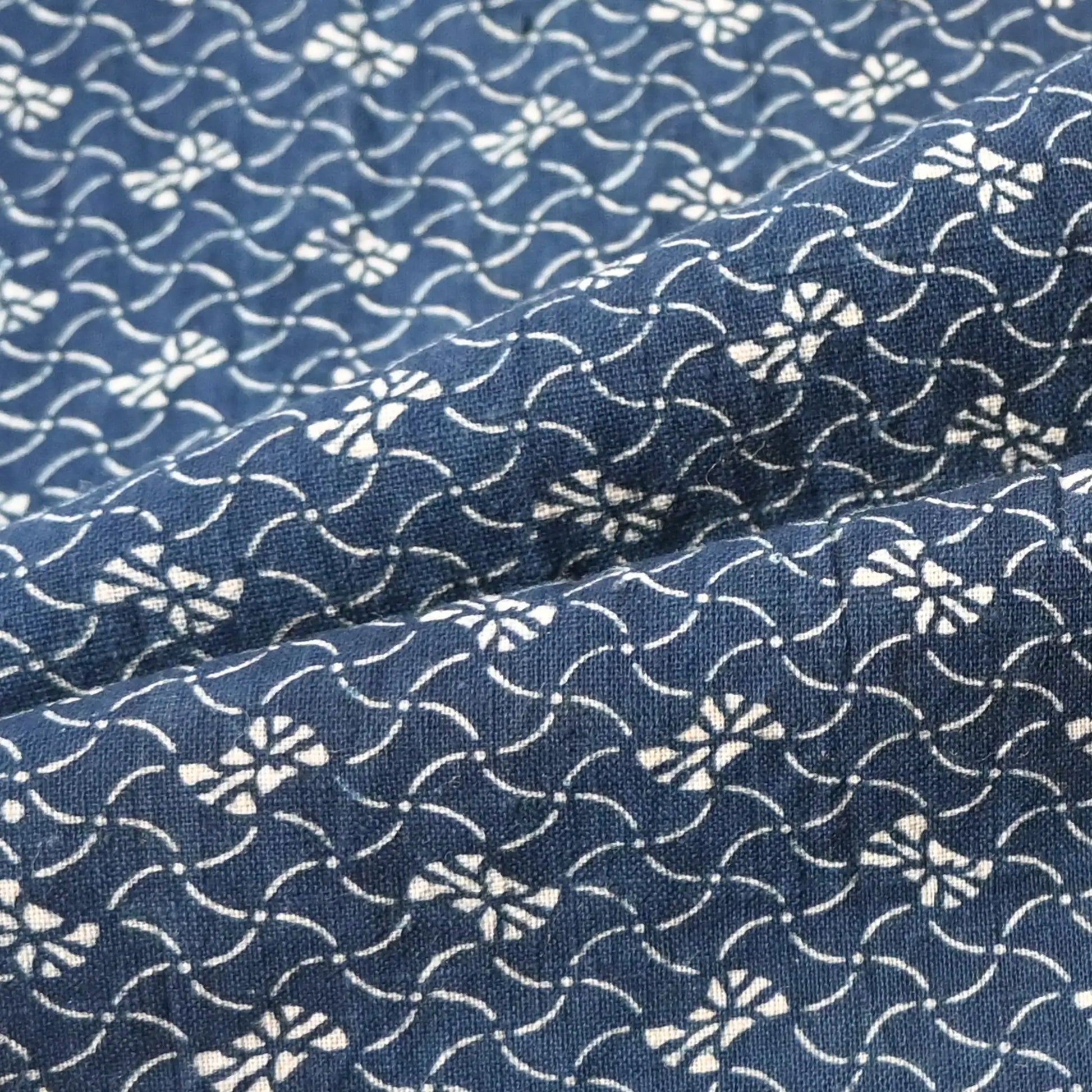 Detailed view of antique Japanese indigo katazome dyed cotton with intricate small pattern from the early 20th century.