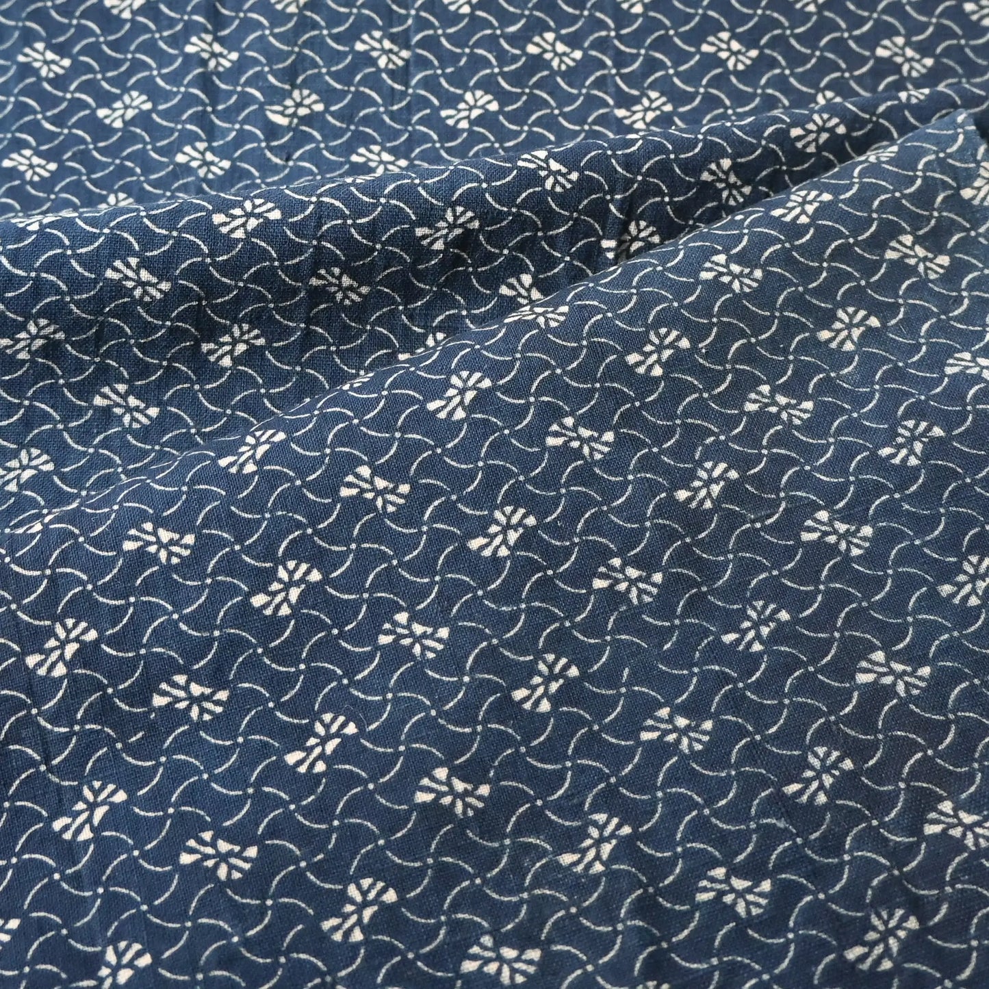 Detailed view of antique Japanese indigo katazome dyed cotton with intricate small pattern from the early 20th century.