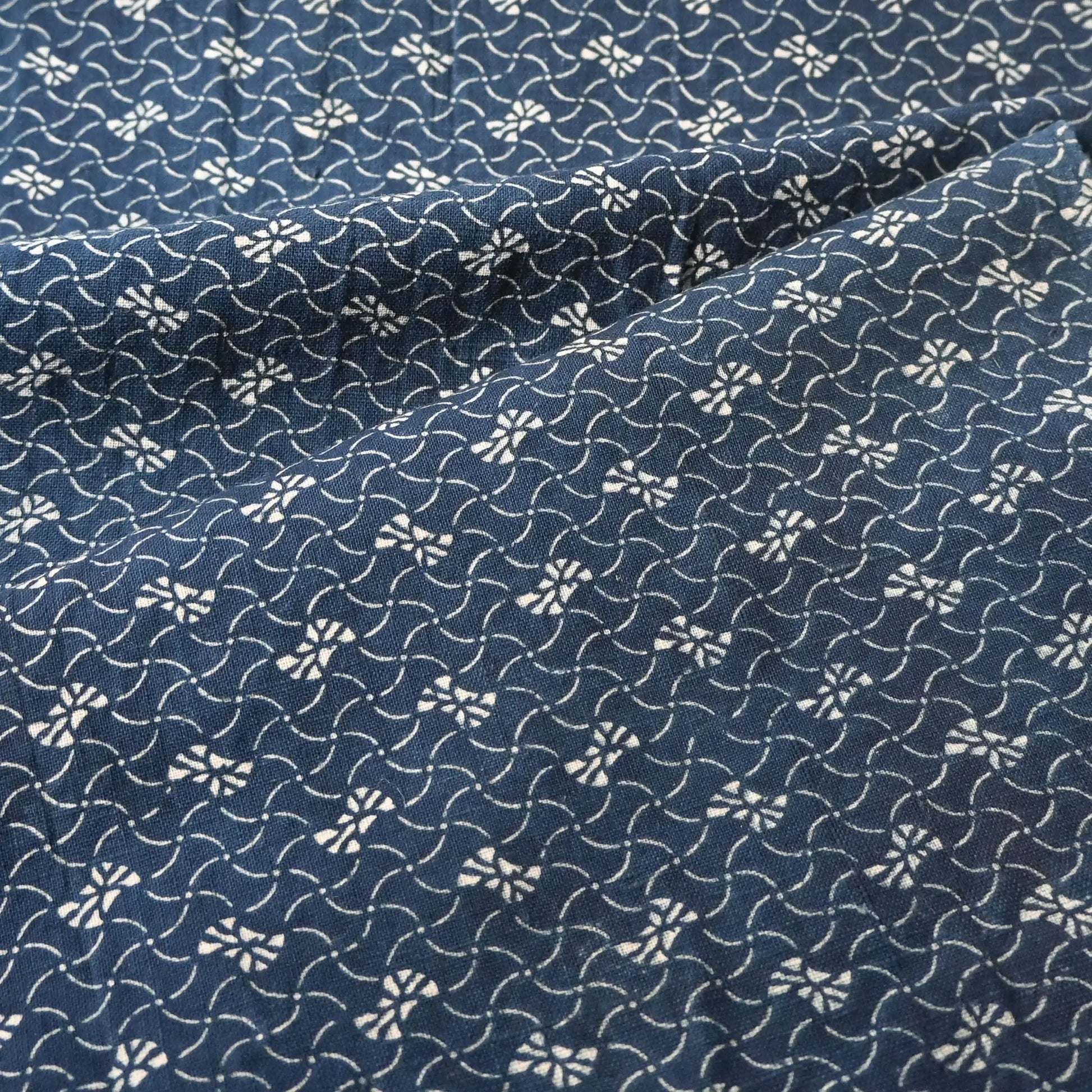 Detailed view of antique Japanese indigo katazome dyed cotton with intricate small pattern from the early 20th century.