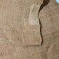 Detailed view of antique Japanese natural thick hemp with a patch, rustic feel.