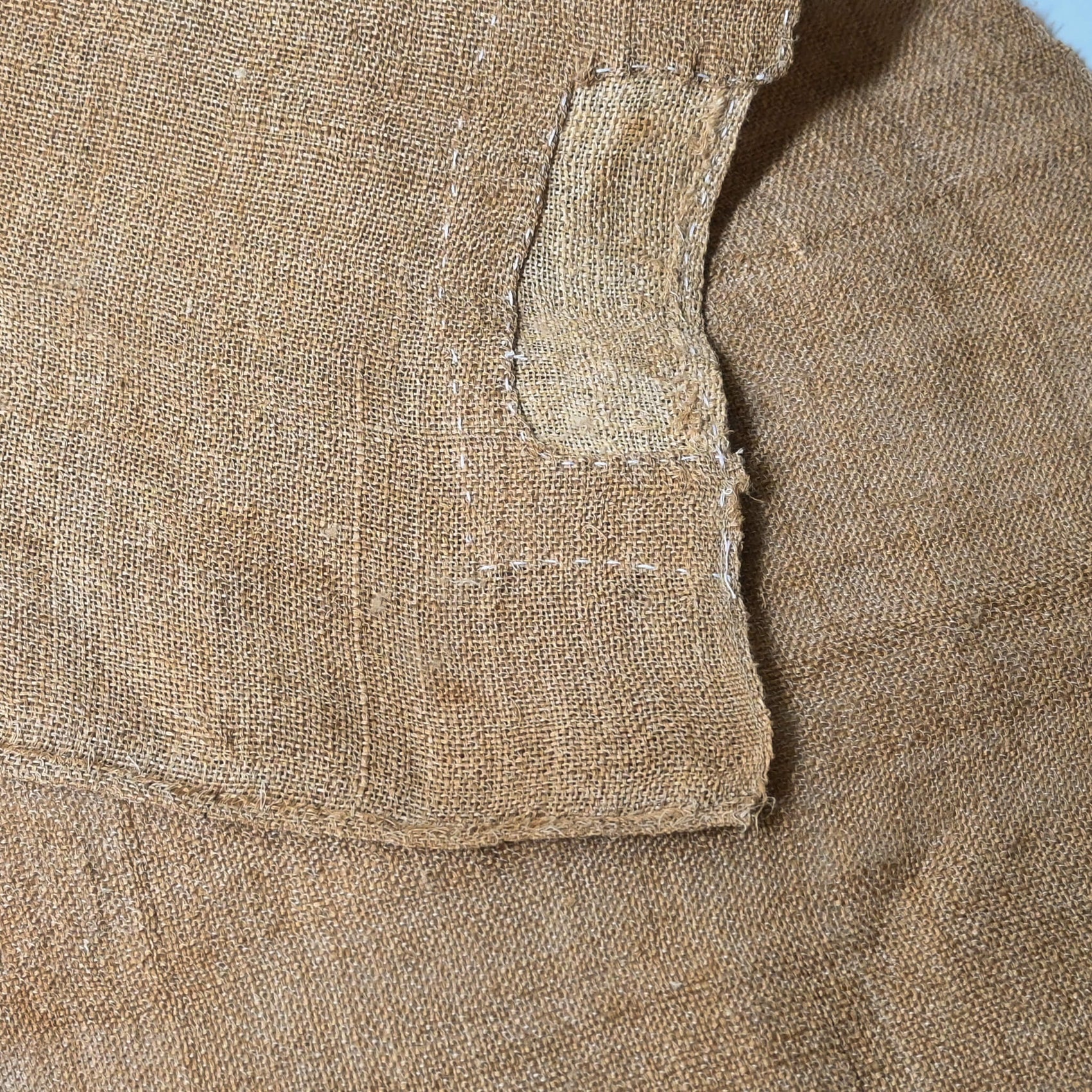 Detailed view of antique Japanese natural thick hemp with a patch, rustic feel.