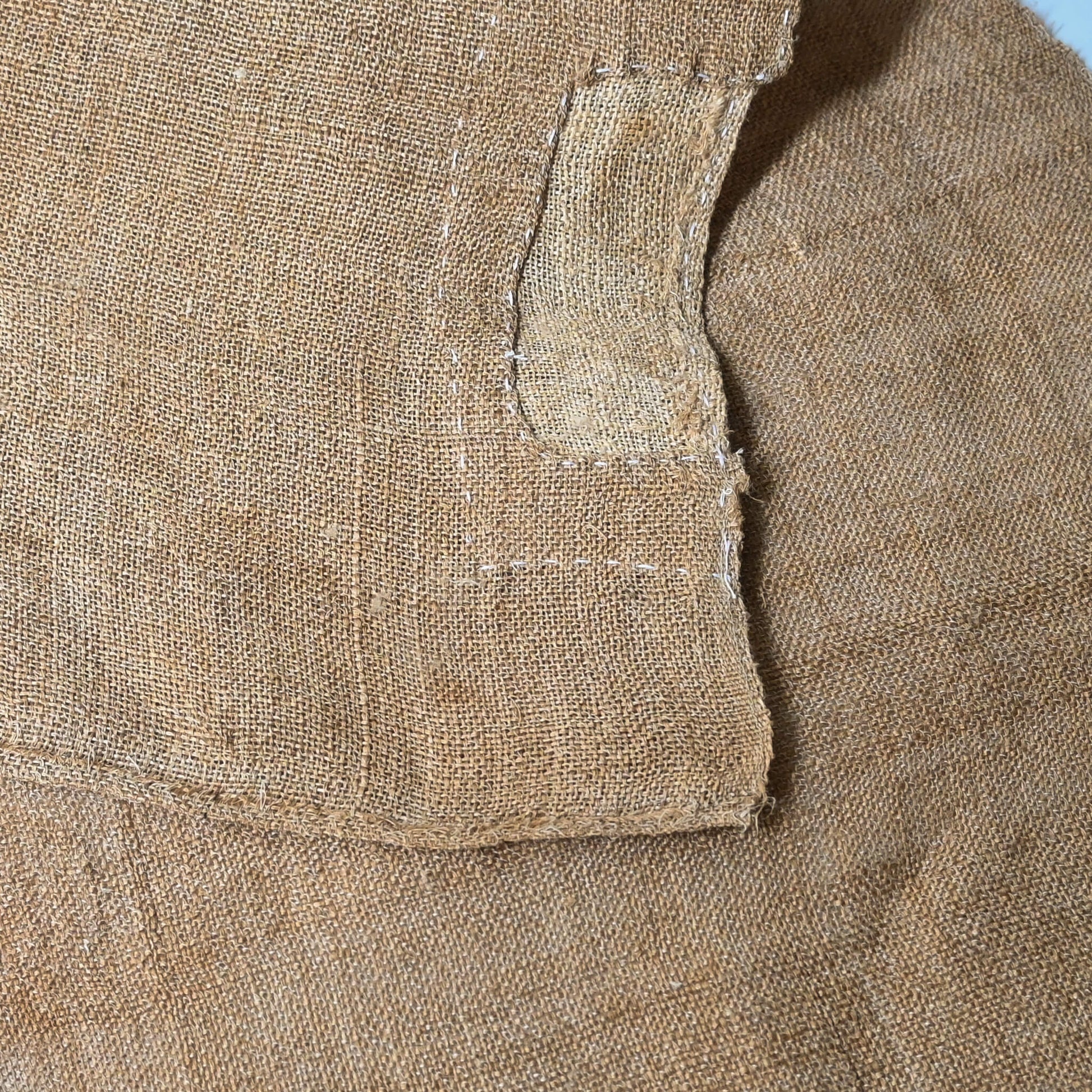 Detailed view of antique Japanese natural thick hemp with a patch, rustic feel.