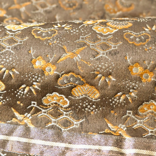 Detailed view of antique Japanese silk brocade Maru Obi with gold and silver threads.