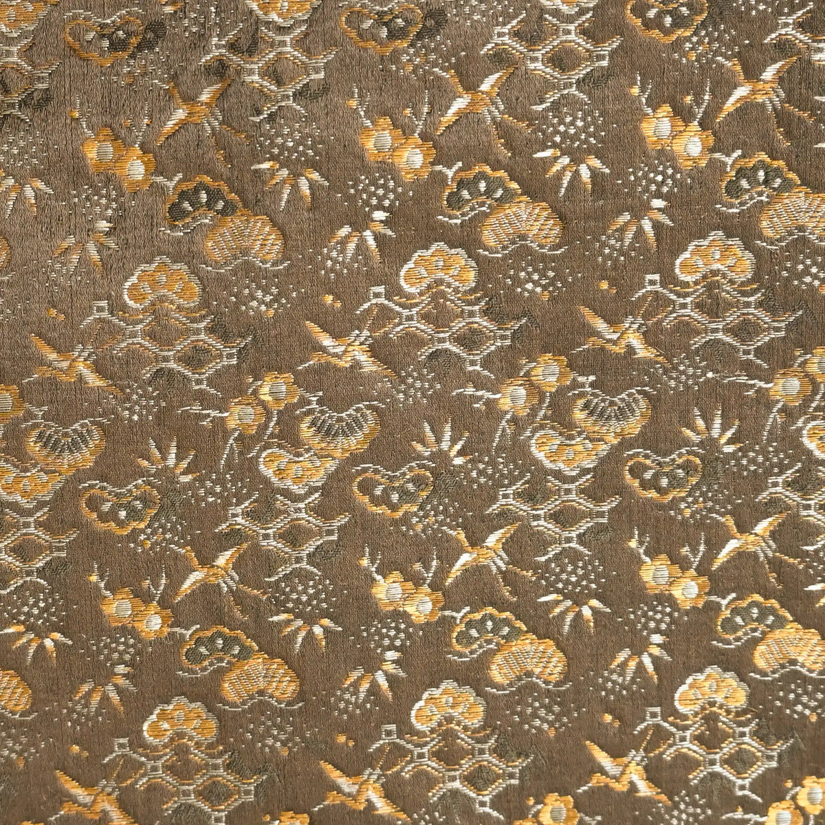 Detailed view of antique Japanese silk brocade Maru Obi with pine trees, bamboos plum blossoms and cranes.