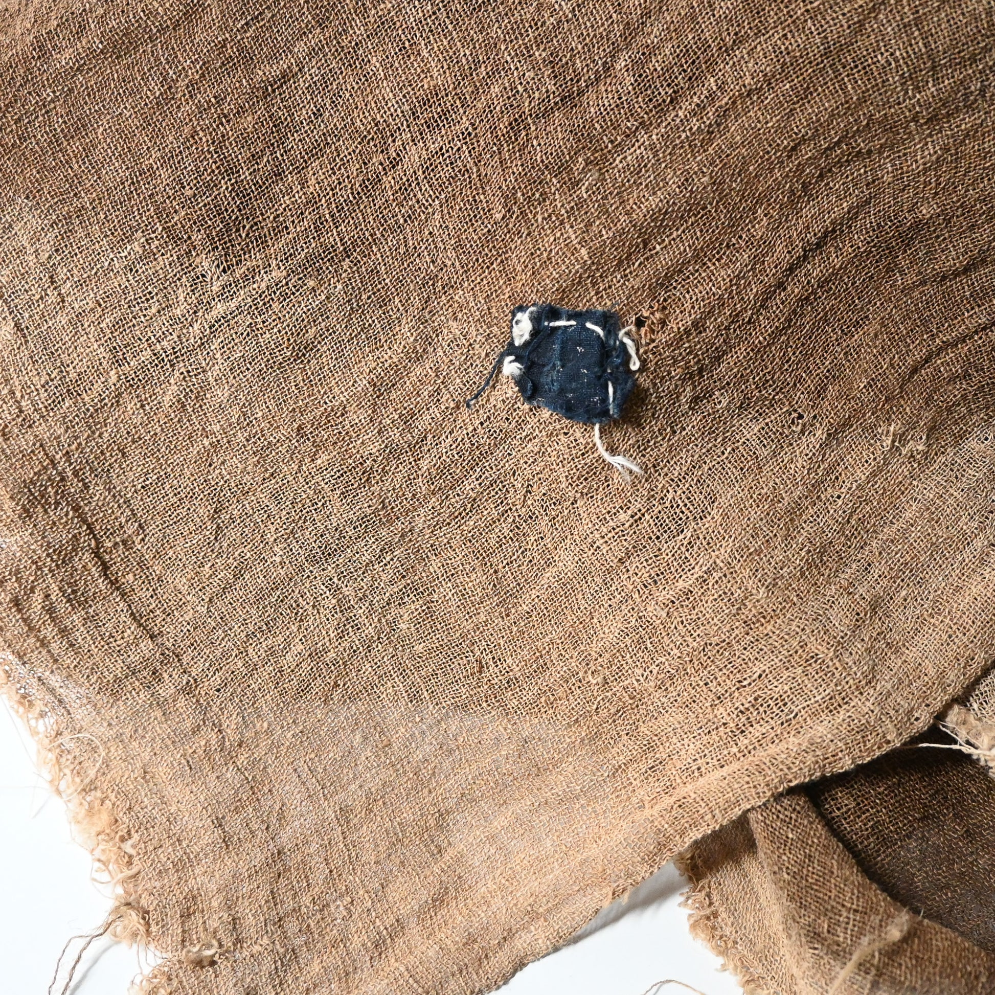 Close-up view of antique Japanese natural brown six-panel hemp mosquito net Kaya with beautiful mends.