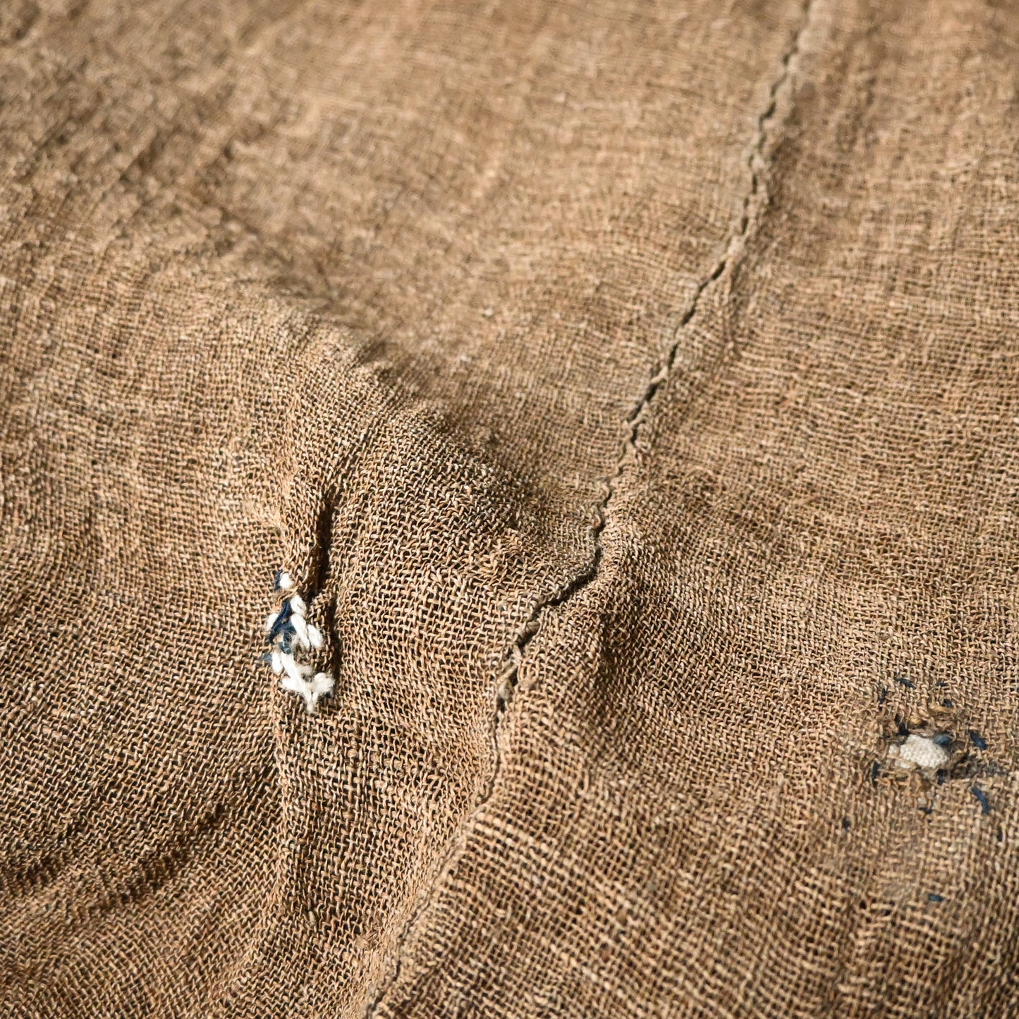 Close-up view of antique Japanese natural brown six-panel hemp mosquito net Kaya with beautiful mends.