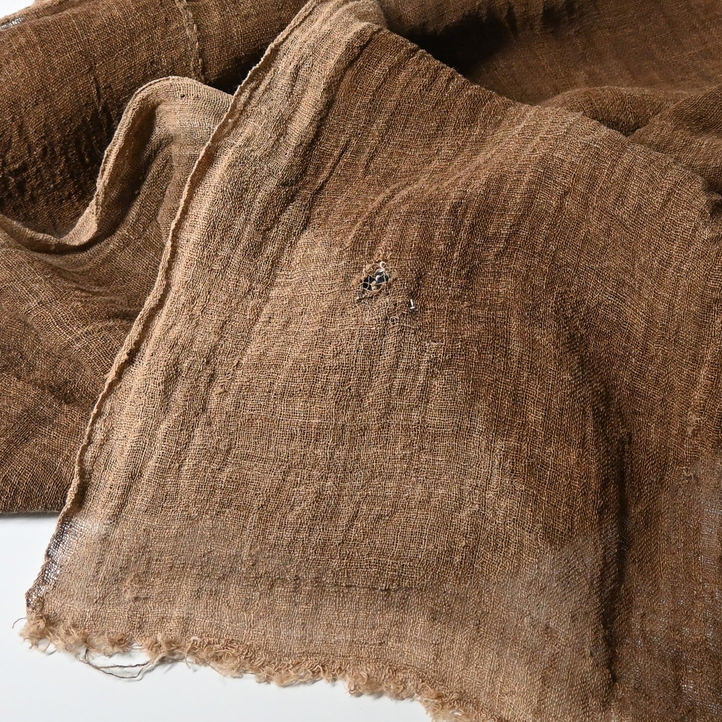 Detailed view of antique Japanese natural brown six-panel hemp mosquito net Kaya with beautiful mends.