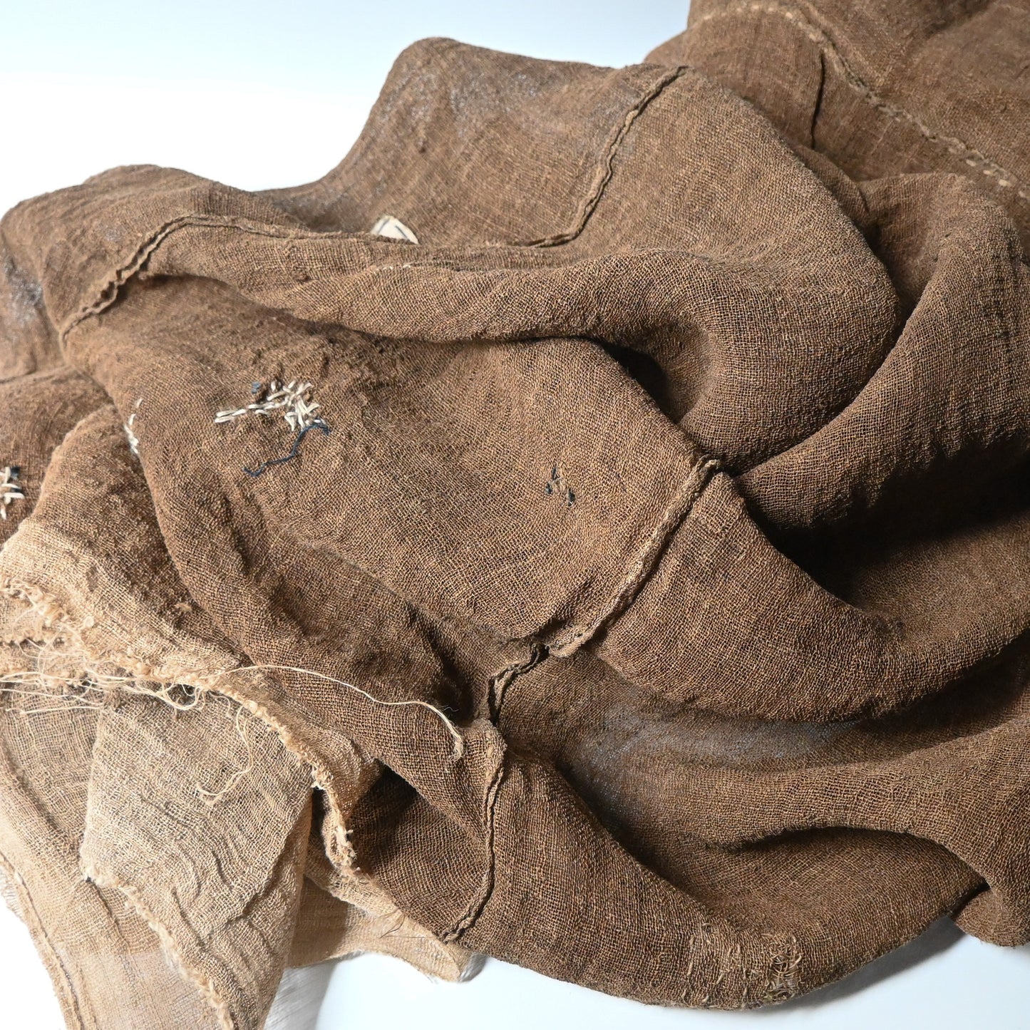 Detailed view of antique Japanese natural brown six-panel hemp mosquito net Kaya with beautiful mends.