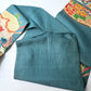 Detailed view of antique Japanese women's teal blue Nagoya obi with gorgeous fan and Kaioke motif from 1930-40s.