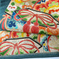 Detailed view of antique Japanese women's teal blue Nagoya obi with gorgeous fan and Kaioke motif from 1930-40s.