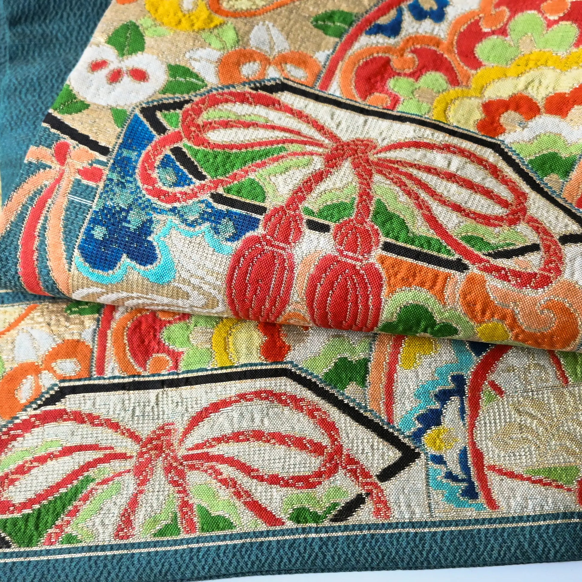 Detailed view of antique Japanese women's teal blue Nagoya obi with gorgeous fan and Kaioke motif from 1930-40s.