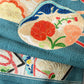 Detailed view of antique Japanese women's teal blue Nagoya obi with gorgeous fan and Kaioke motif from 1930-40s.
