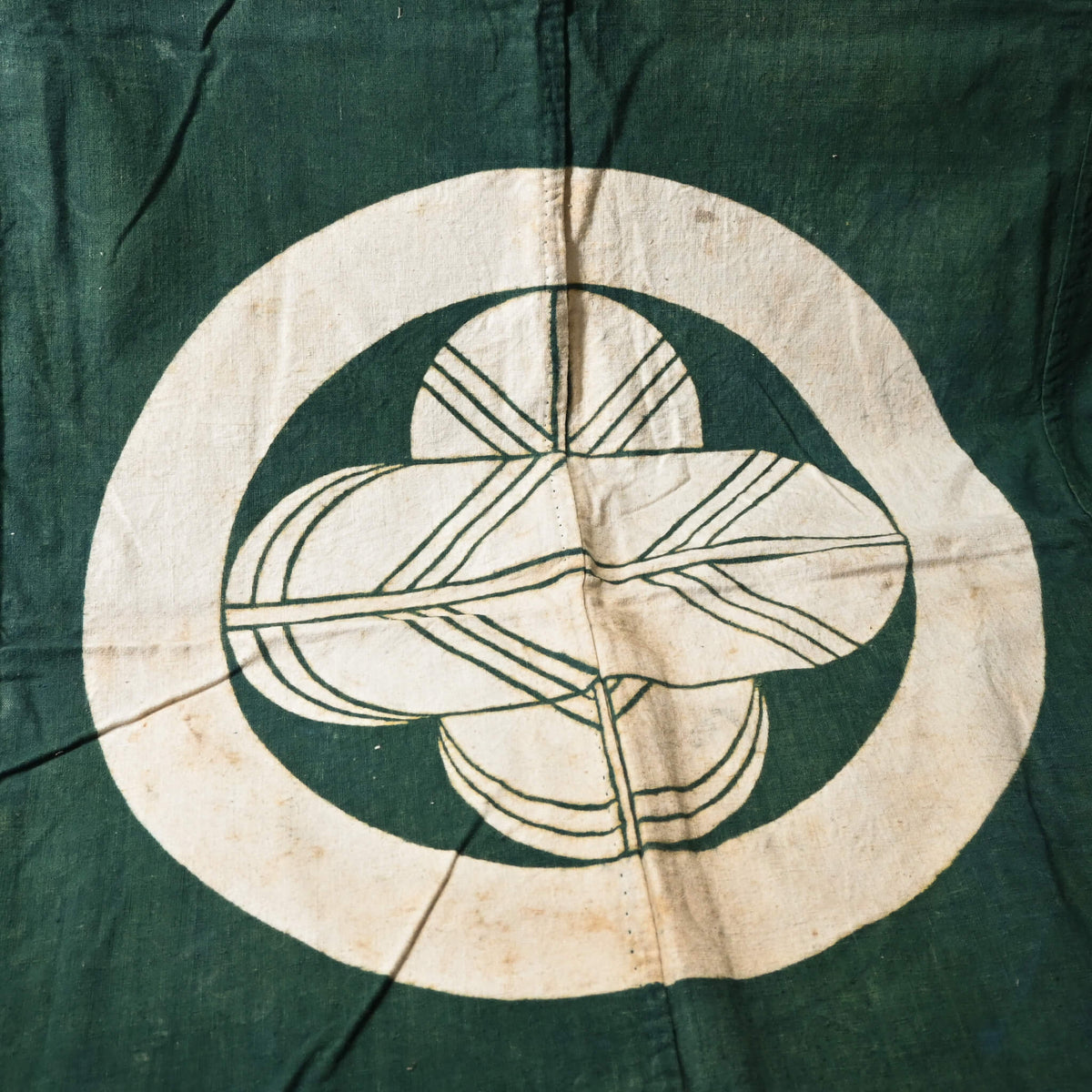 Antique indigo green cotton furoshiki with family crest mon from the early 20th century.