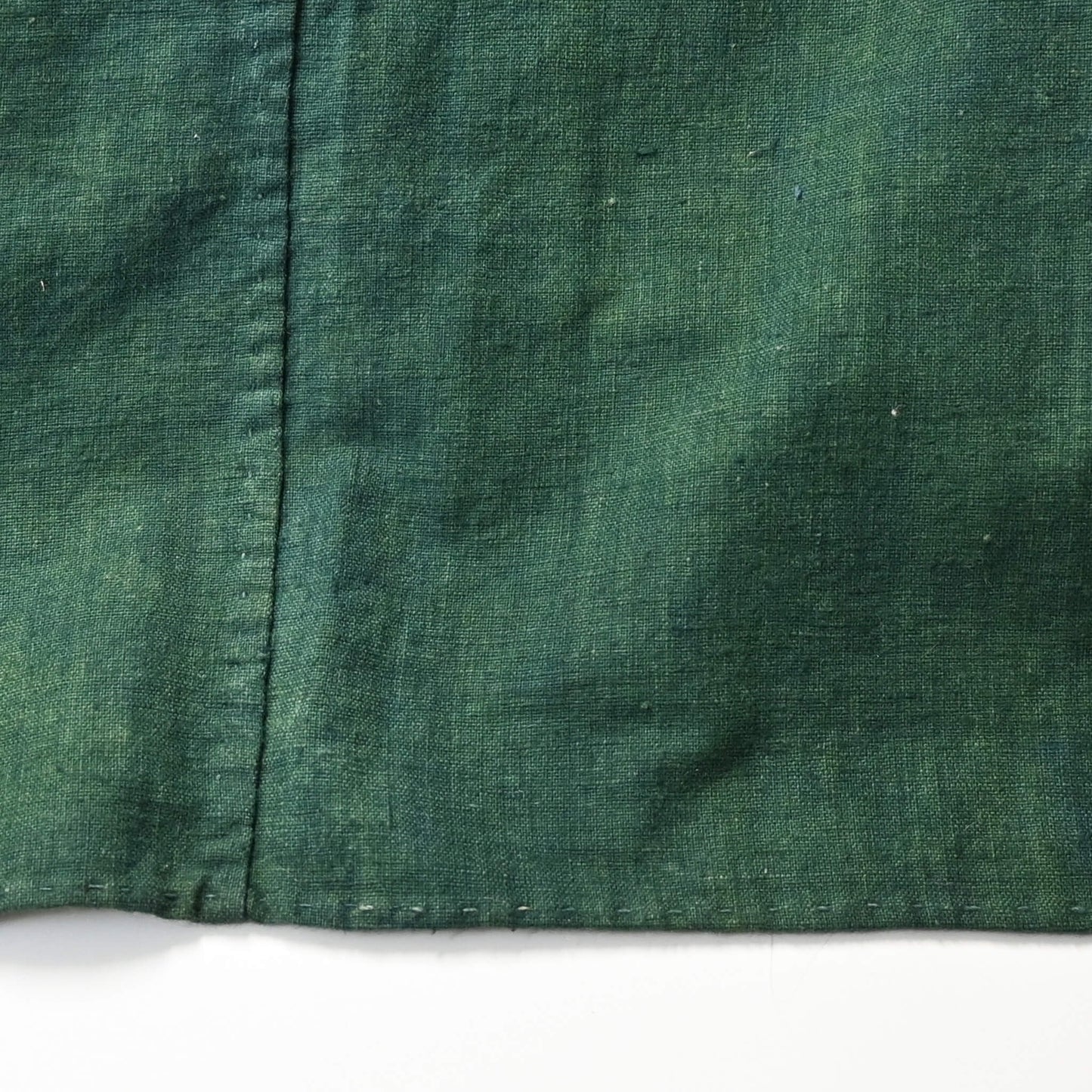 Detailed view of antique indigo green cotton furoshiki with family crest mon from the early 20th century.