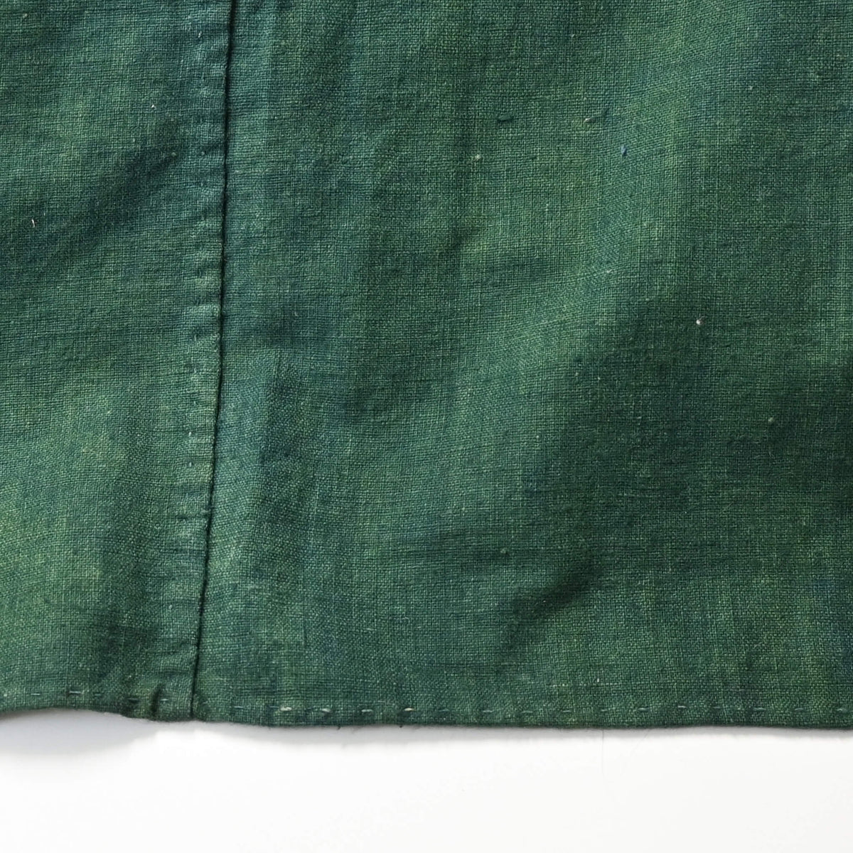 Detailed view of antique indigo green cotton furoshiki with family crest mon from the early 20th century.