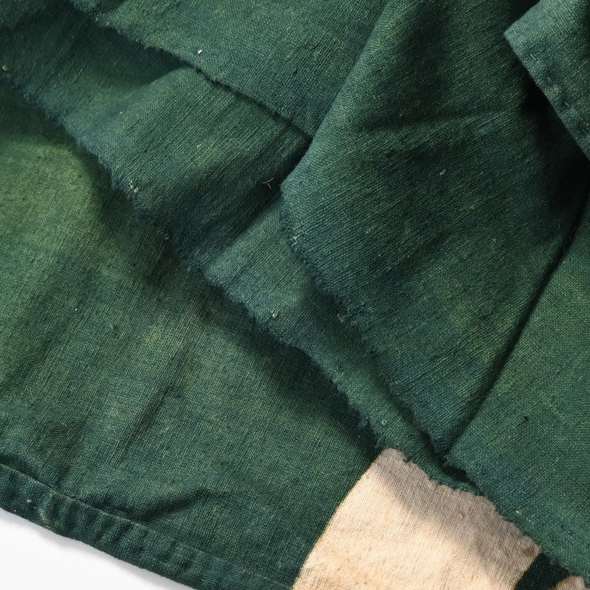 Detailed view of antique indigo green cotton furoshiki with family crest mon from the early 20th century.
