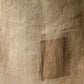 Detailed view of antique natural wide width hemp cloth with mends with rustic feel.