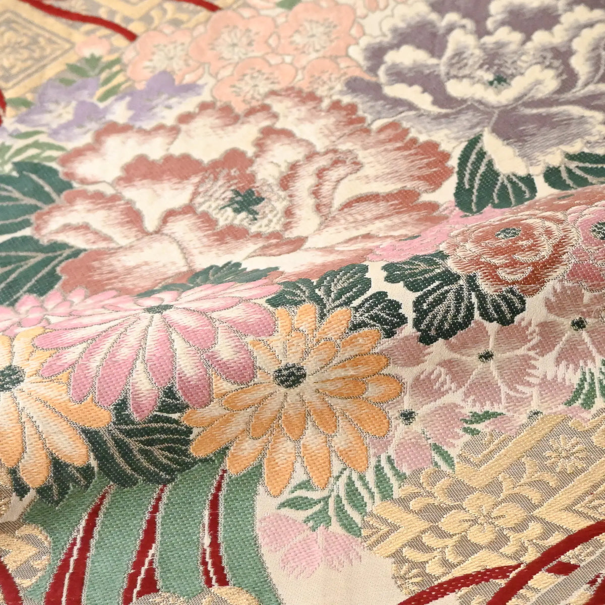 Detailed view of antique silk Maru obi with floral bouquet motif from the early 20th century.