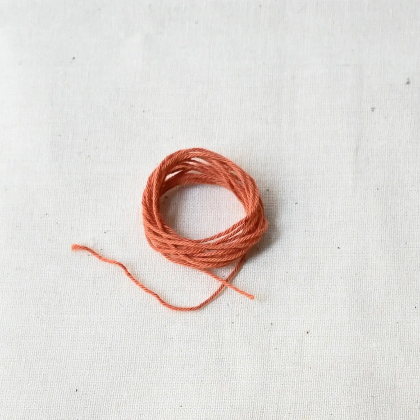 Authentic Japanese sashiko threads hank from Hida, Gifu, in papaya orange.