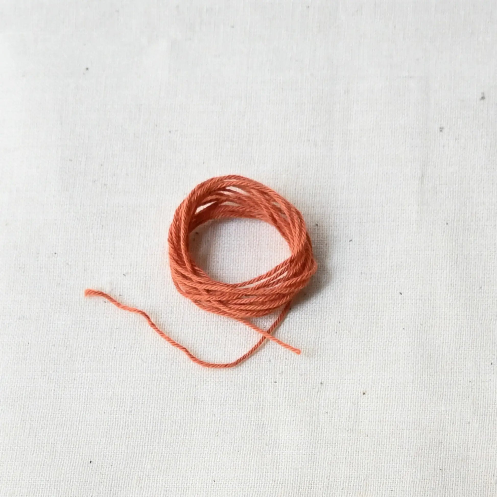 Authentic Japanese sashiko threads hank from Hida, Gifu, in papaya orange.