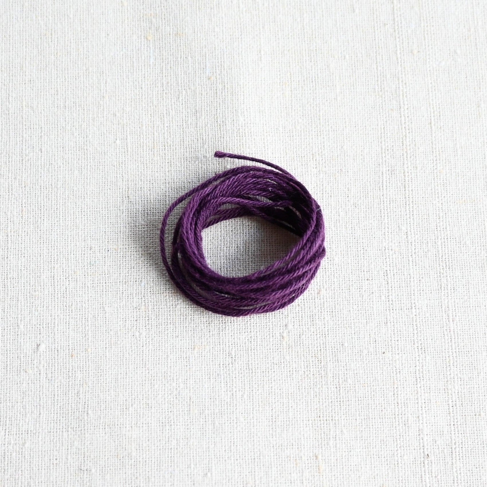 Authentic Japanese Hida sashiko threads in aubergine on calico cotton.