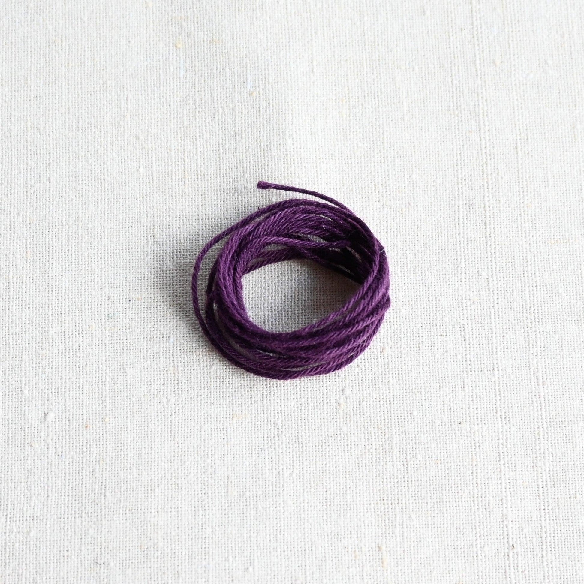 Authentic Japanese Hida sashiko threads in aubergine on calico cotton.