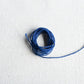 Authentic Japanese Hida sashiko threads in blue on calico cotton.