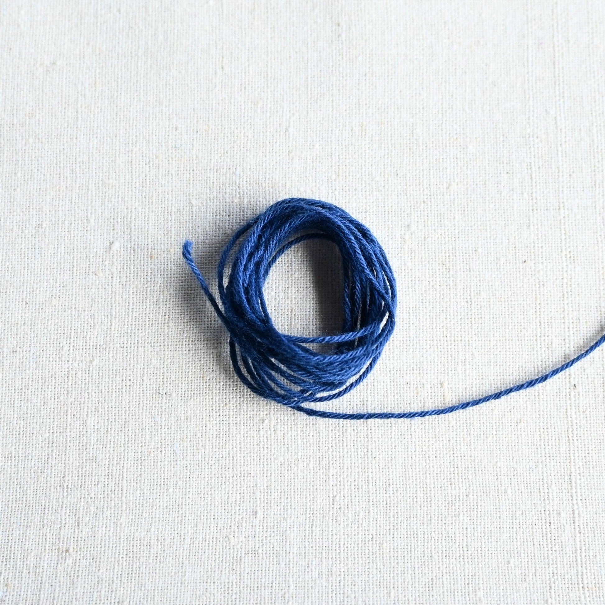 Authentic Japanese Hida sashiko threads in blue on calico cotton.
