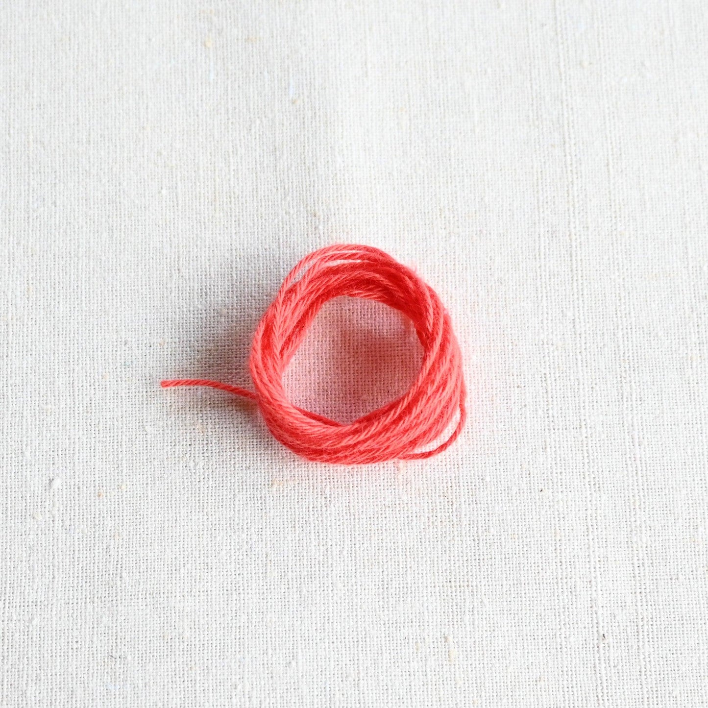 Authentic Japanese Hida sashiko threads in coral on calico cotton.