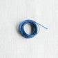 Authentic Japanese Hida sashiko threads in light blue on calico cotton.
