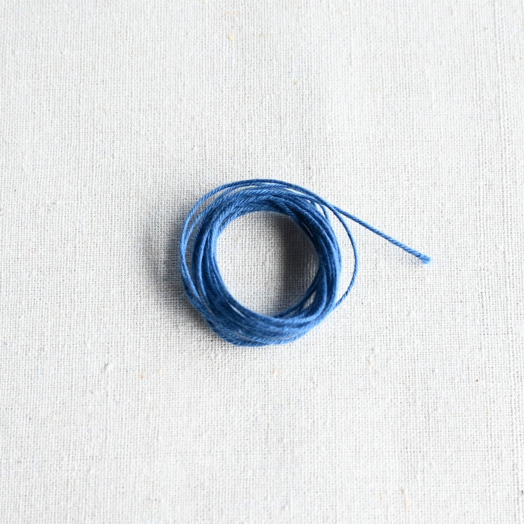 Authentic Japanese Hida sashiko threads in light blue on calico cotton.