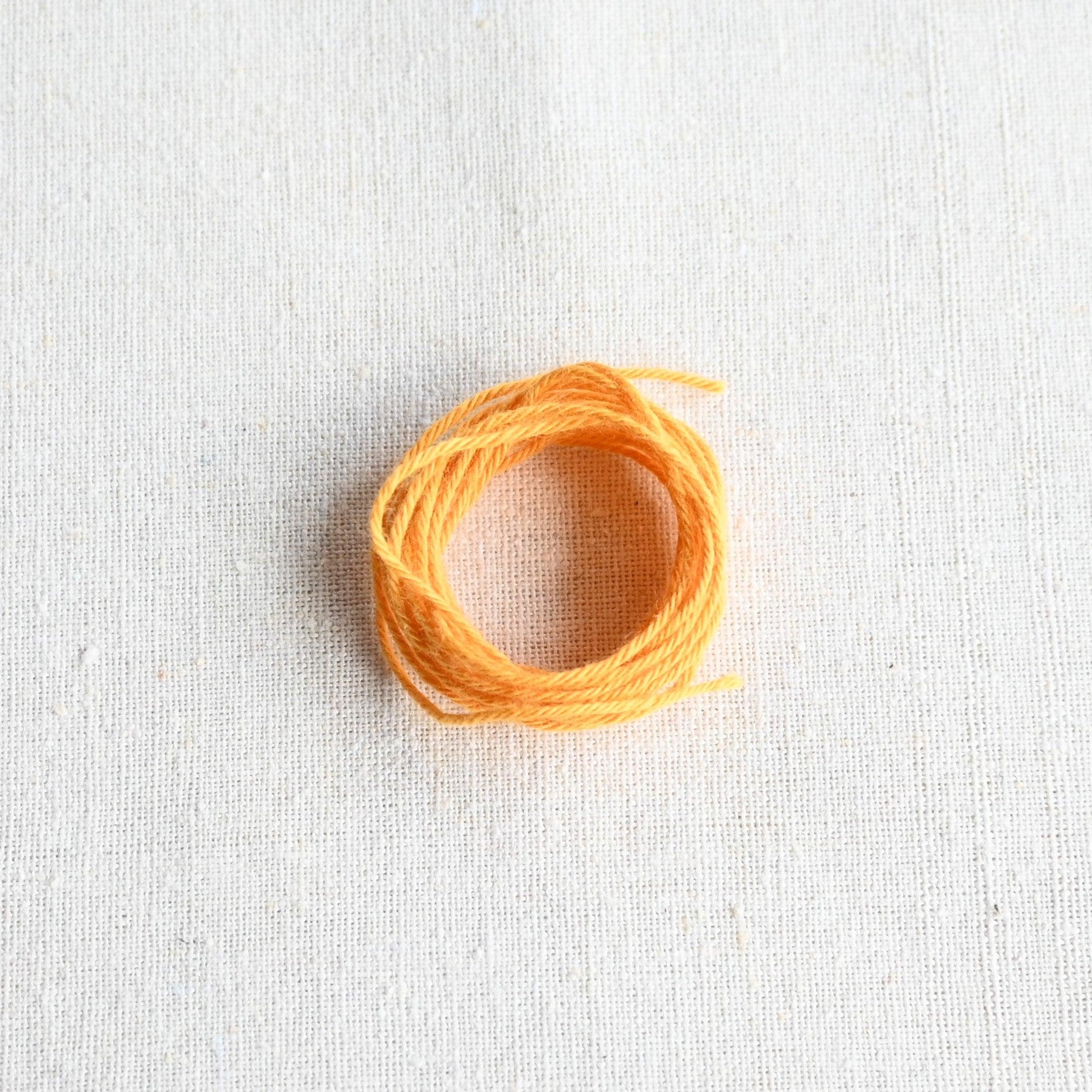 Authentic Japanese Hida sashiko threads in mustard on calico cotton.