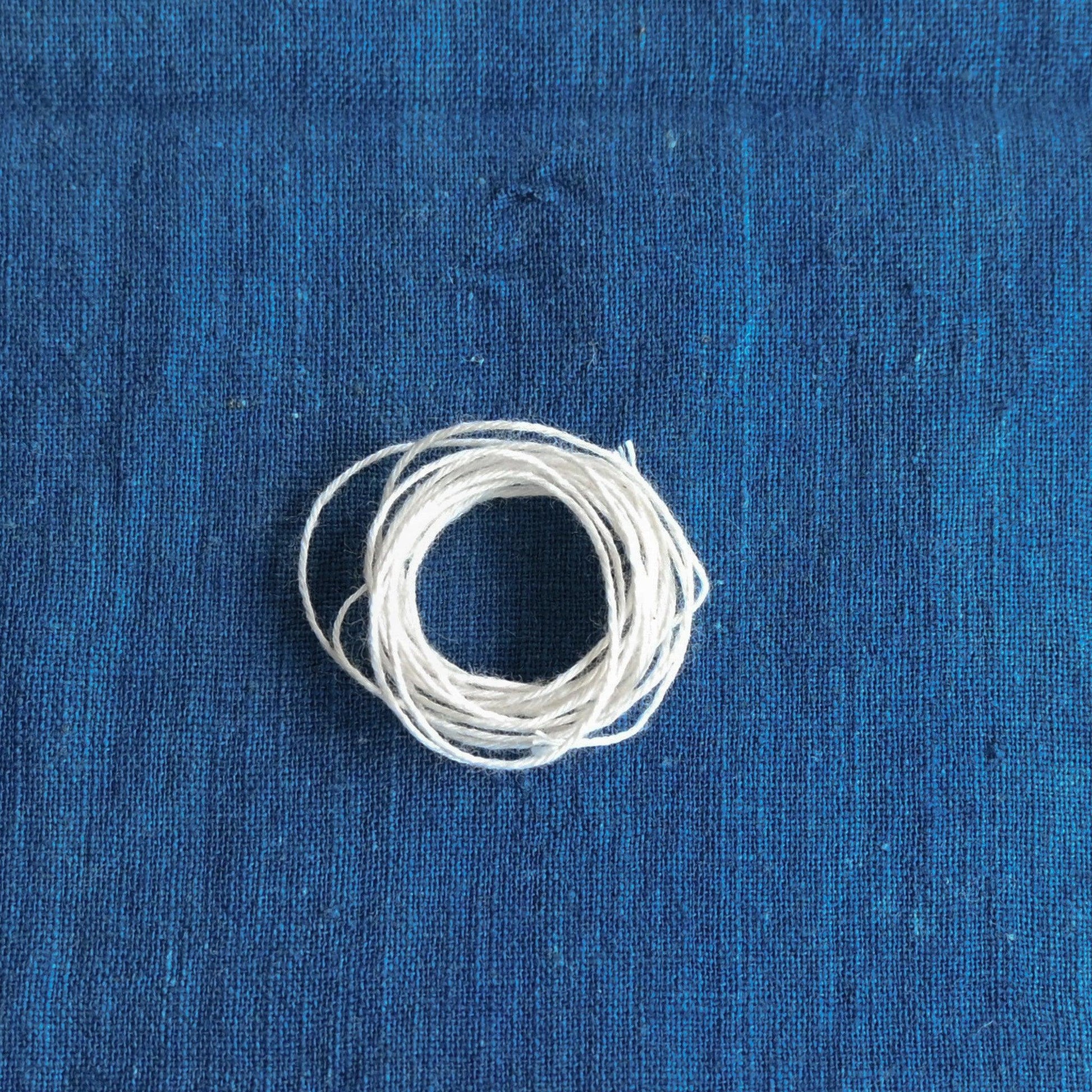 Authentic Japanese Sashiko natural sashiko thread on indigo cotton.