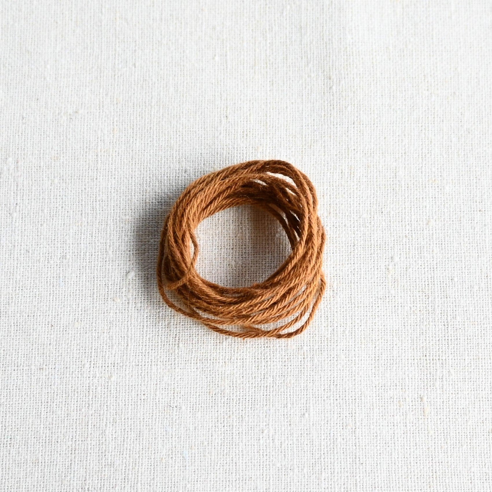 Authentic Japanese Hida sashiko threads in ochre on calico cotton.