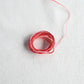 Authentic Japanese Hida sashiko threads in red gradation on calico cotton.