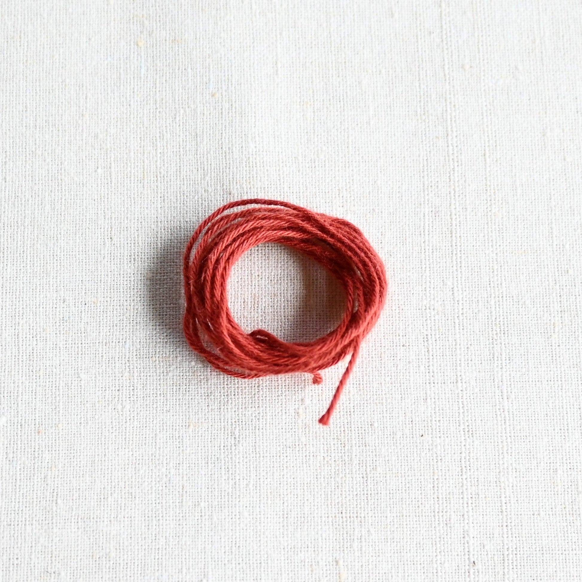 Authentic Japanese Hida sashiko threads in terracotta on calico cotton.